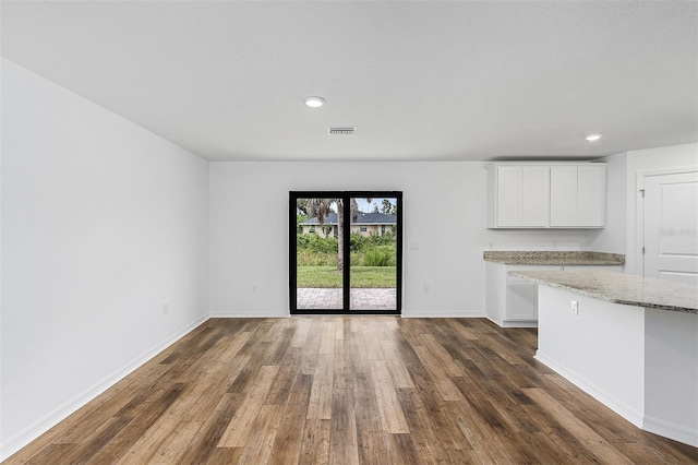 unfurnished living room featuring dark hardwood / wood-style floors