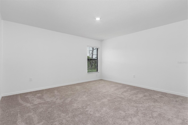 empty room featuring light colored carpet