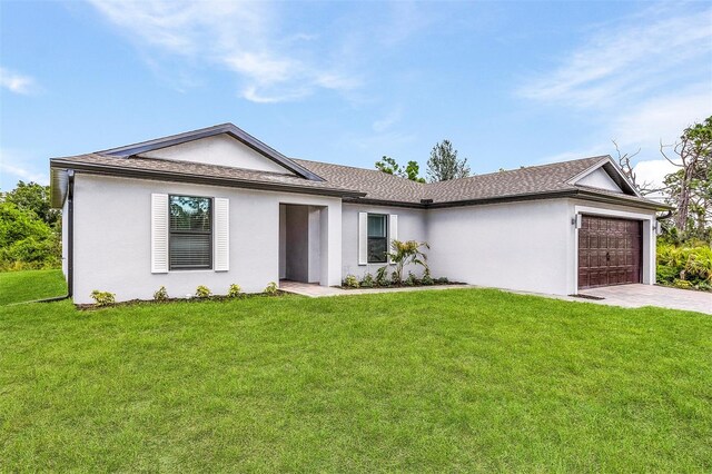 ranch-style house featuring a garage and a front yard