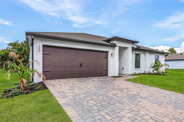 view of front of property featuring a garage and a front yard