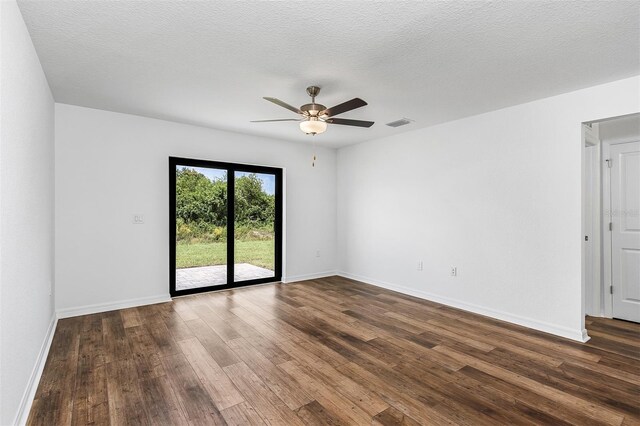 unfurnished room featuring a textured ceiling, ceiling fan, and dark hardwood / wood-style floors