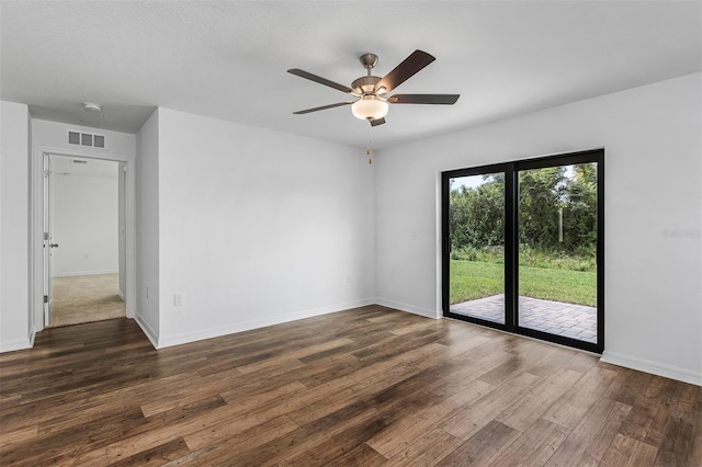 unfurnished room featuring dark wood-type flooring and ceiling fan