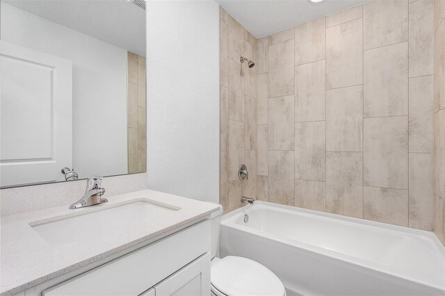 full bathroom with tiled shower / bath combo, vanity, and toilet