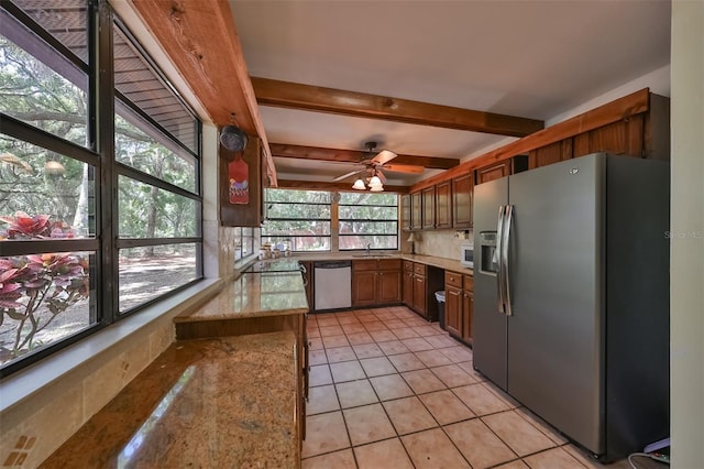 kitchen with light stone counters, light tile patterned floors, kitchen peninsula, ceiling fan, and stainless steel appliances