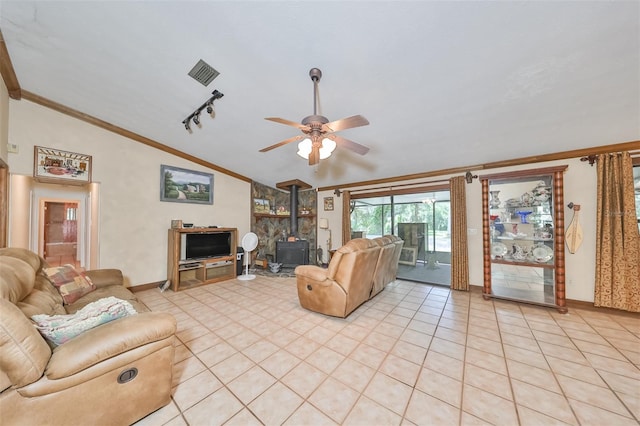 tiled living room with vaulted ceiling, rail lighting, a wood stove, ceiling fan, and crown molding