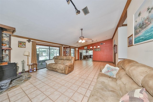 living room with light tile patterned floors, vaulted ceiling, ornamental molding, and ceiling fan