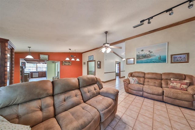 tiled living room with rail lighting, lofted ceiling, ornamental molding, and ceiling fan