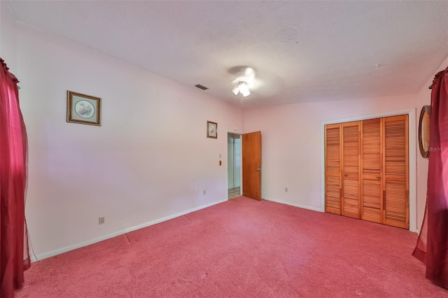 unfurnished bedroom featuring light colored carpet and a closet