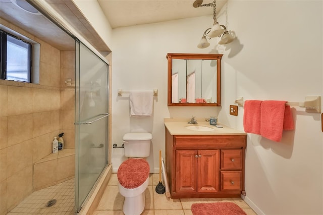 bathroom featuring vanity, a shower with shower door, tile patterned floors, and toilet