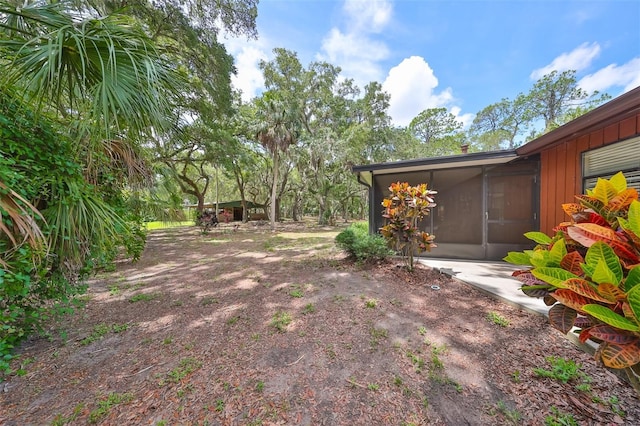 view of yard with a sunroom