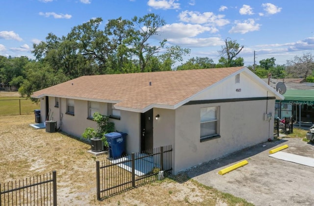 rear view of house with central air condition unit