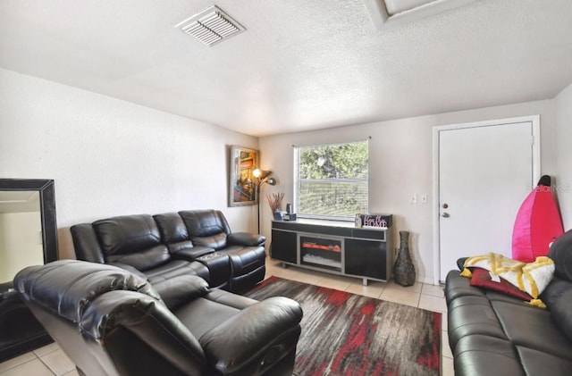 tiled living room with a textured ceiling