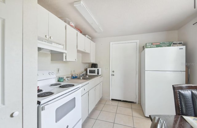 kitchen featuring white cabinets, white appliances, sink, and light tile patterned flooring