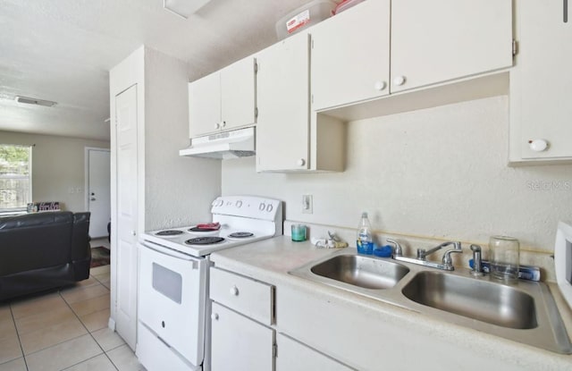 kitchen featuring electric stove, sink, white cabinets, and light tile patterned flooring