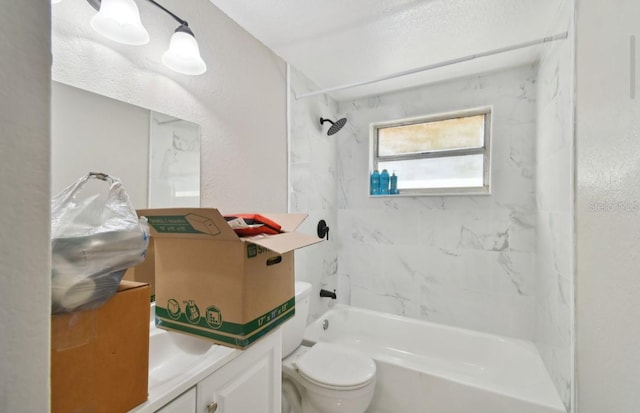 full bathroom with tiled shower / bath combo, toilet, and vanity