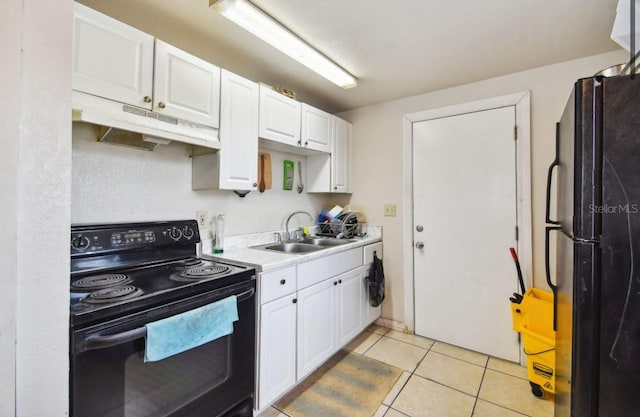 kitchen featuring black appliances, light tile patterned flooring, white cabinetry, and sink