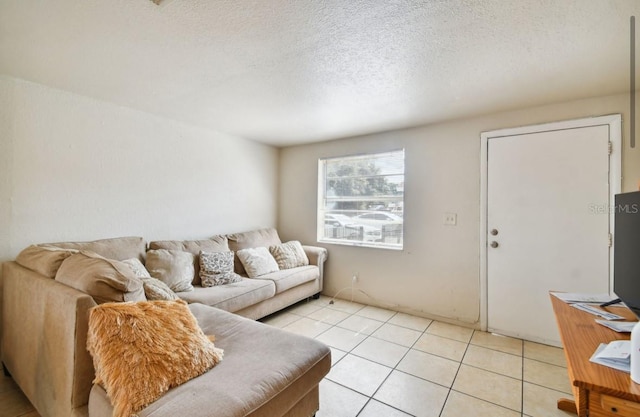 living room with light tile patterned floors and a textured ceiling