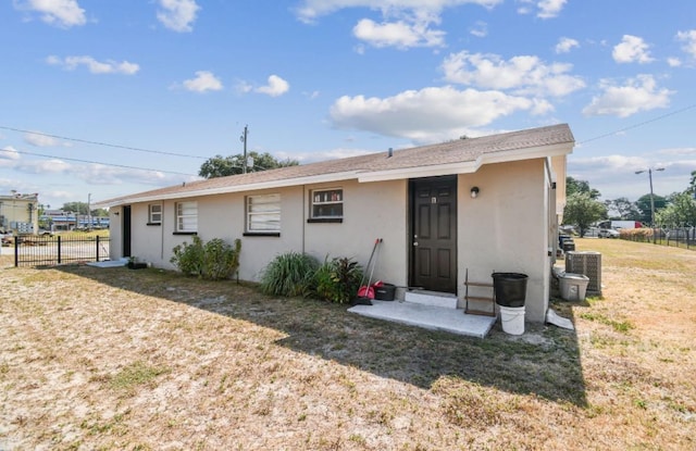 rear view of property with a yard