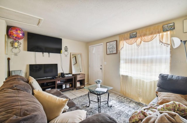 tiled living room featuring a textured ceiling