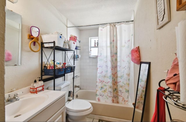 full bathroom with vanity, toilet, a textured ceiling, and shower / tub combo