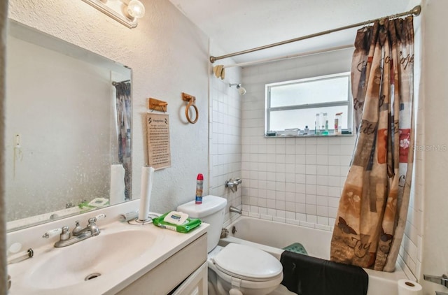 full bathroom with vanity, shower / tub combo, and toilet