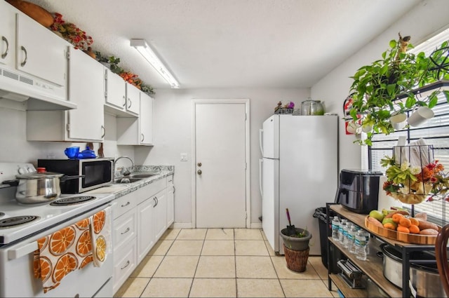 kitchen featuring white cabinets, white appliances, sink, and light tile patterned floors