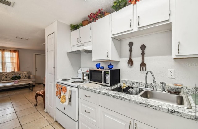 kitchen with electric stove, sink, white cabinets, and light tile patterned flooring