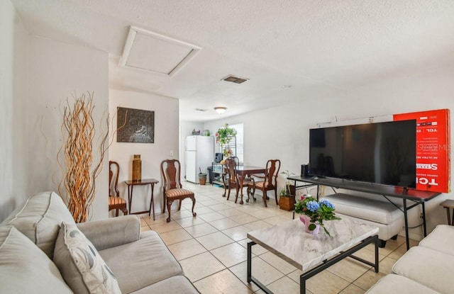 living room with light tile patterned floors and a textured ceiling