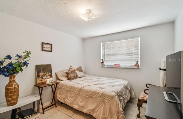 tiled bedroom featuring a textured ceiling