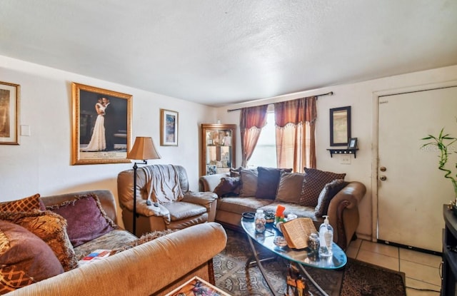 living room featuring a textured ceiling and tile patterned floors