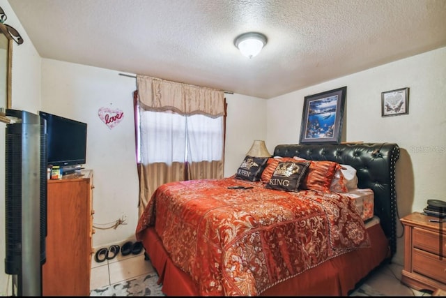 tiled bedroom with a textured ceiling