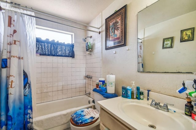 full bathroom featuring vanity, toilet, shower / bathtub combination with curtain, and a textured ceiling