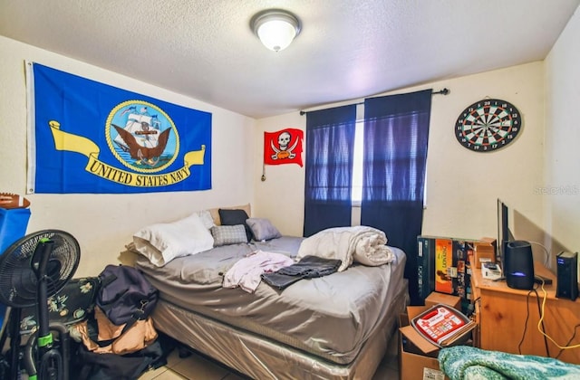 bedroom with tile patterned flooring and a textured ceiling