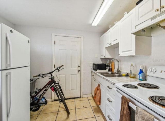 kitchen featuring white cabinetry, light tile patterned flooring, white appliances, and sink