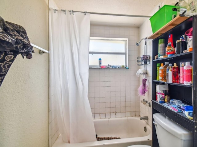 bathroom featuring shower / tub combo and toilet