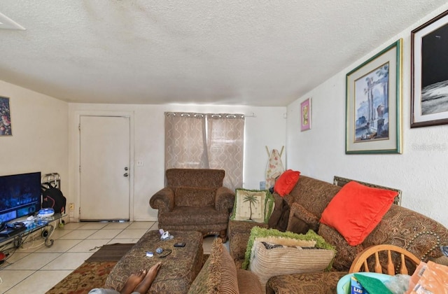 living room featuring light tile patterned floors and a textured ceiling