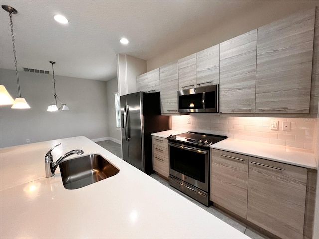 kitchen featuring decorative light fixtures, sink, decorative backsplash, and stainless steel appliances