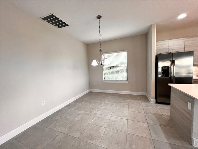 unfurnished dining area featuring light tile patterned floors