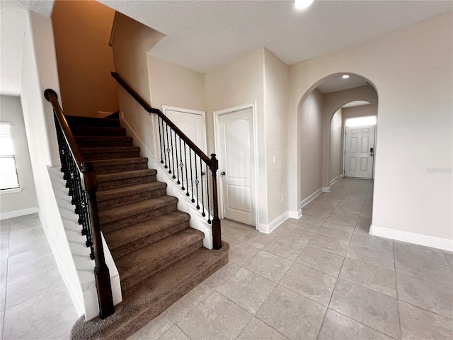 stairway with tile patterned floors