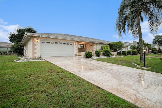 single story home featuring a garage and a front lawn