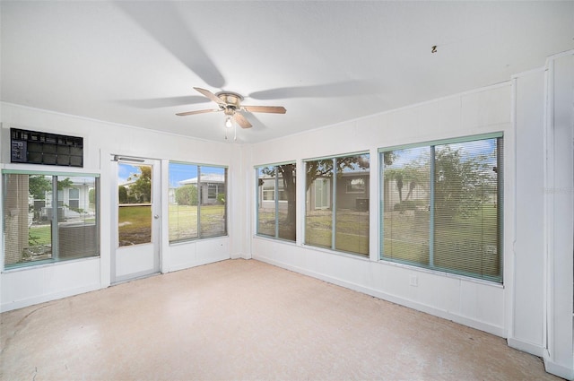 unfurnished sunroom featuring ceiling fan