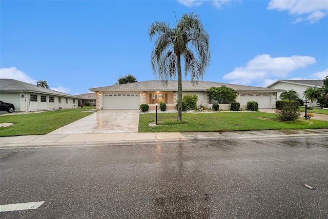 ranch-style house featuring a garage and a front lawn