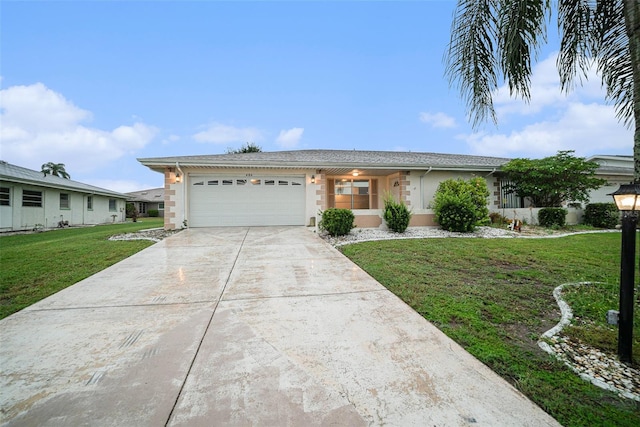 ranch-style home featuring a garage and a front lawn