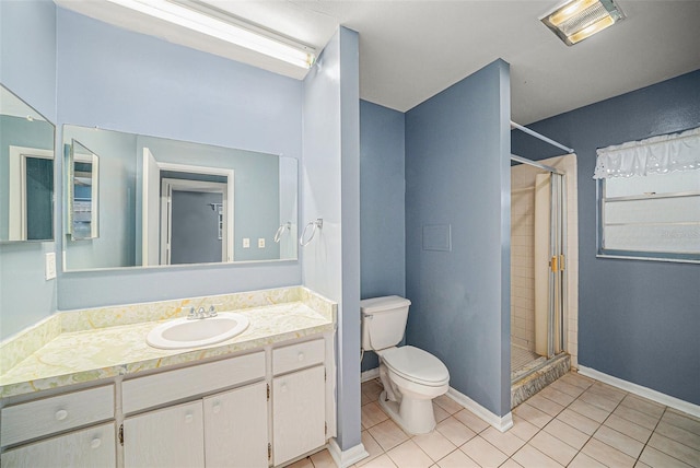 bathroom featuring tile patterned flooring, toilet, a tile shower, and vanity