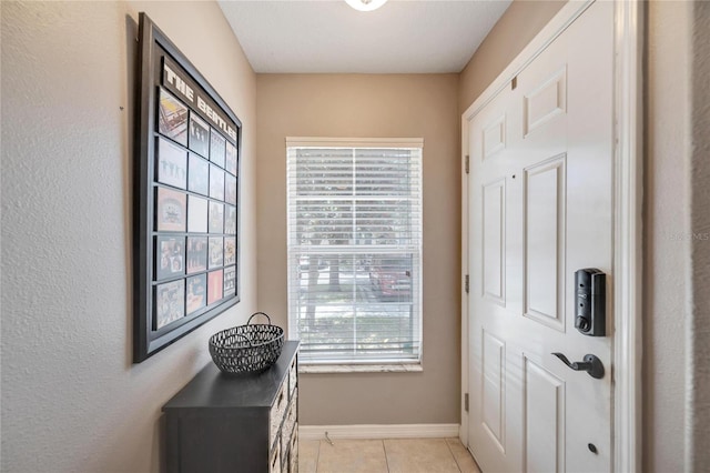 doorway with light tile patterned floors