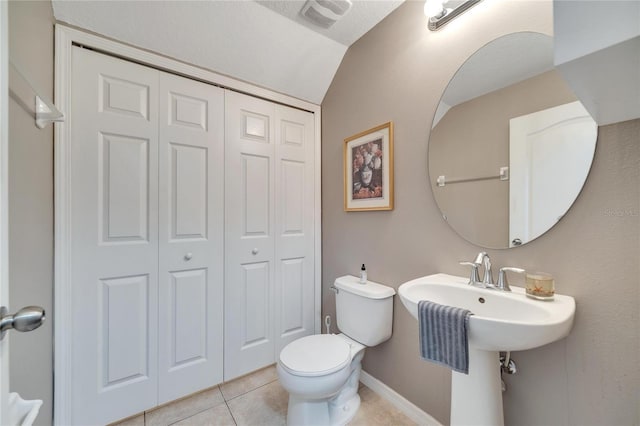 bathroom featuring tile patterned floors, toilet, and lofted ceiling