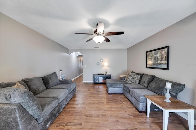 living room with ceiling fan and light hardwood / wood-style flooring