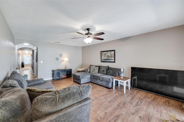 living room featuring ceiling fan and wood-type flooring