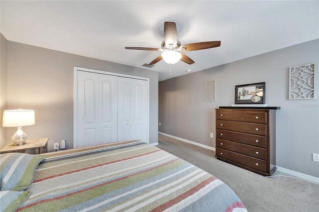 carpeted bedroom with a closet and ceiling fan