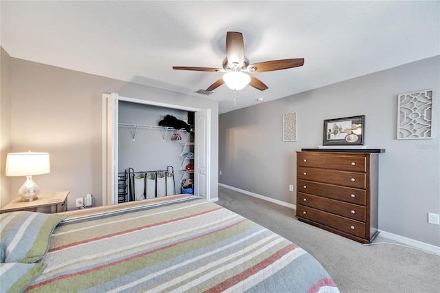 bedroom featuring ceiling fan, light carpet, and a closet